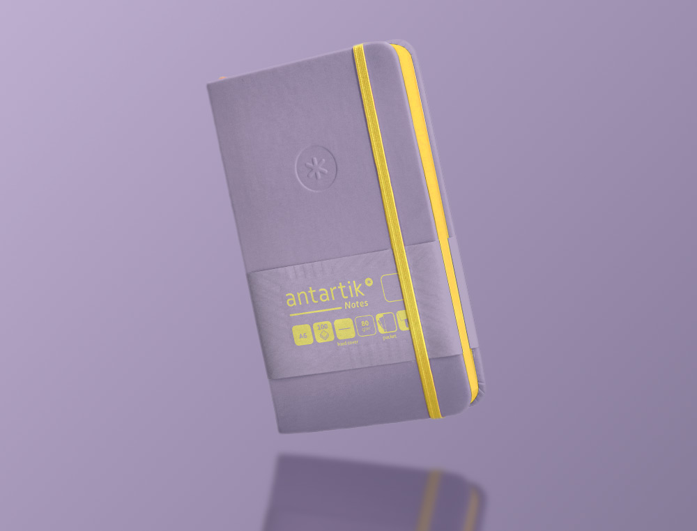 CADERNO COM ELASTICO ANTARTIK NOTES CAPA DURA A6 LISO ROXO E AMARELO 100 FOLHAS 80 GR FSC
